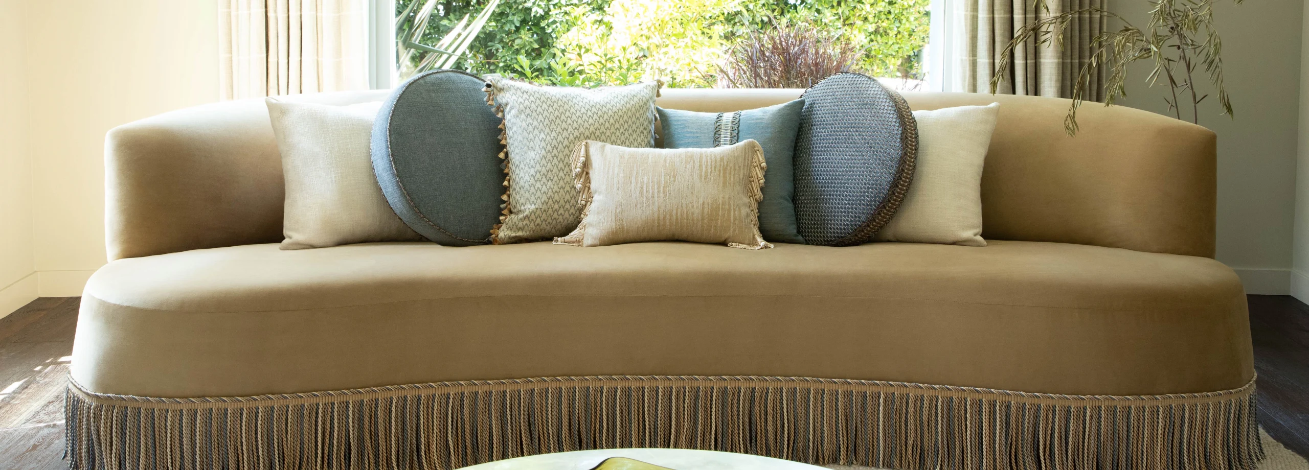 Antique-style chair with embroidered cushion and pastel fringe trim detailing from India